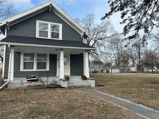 bungalow-style home featuring a porch and a front yard