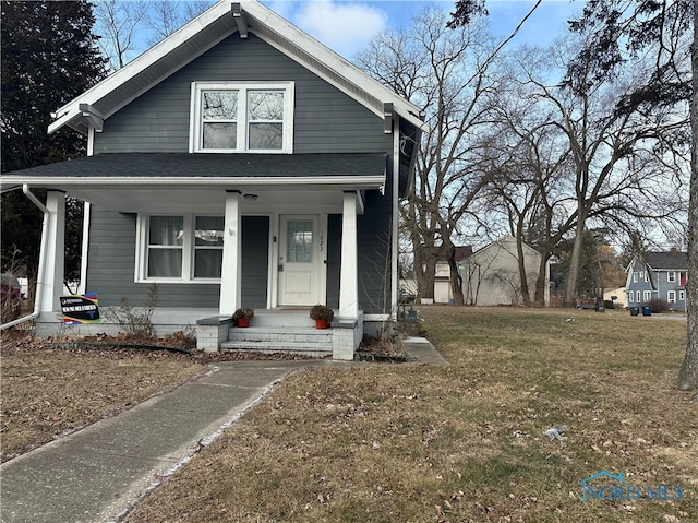 bungalow-style home with a porch and a front lawn