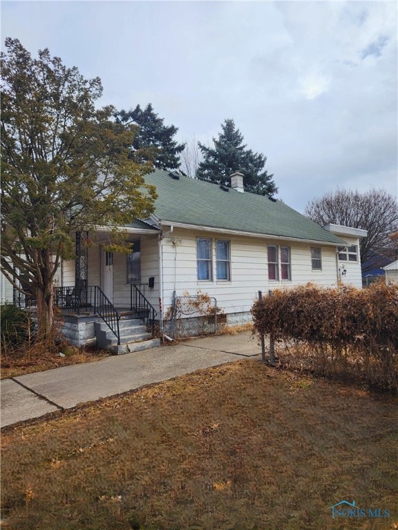 view of front of home featuring a chimney