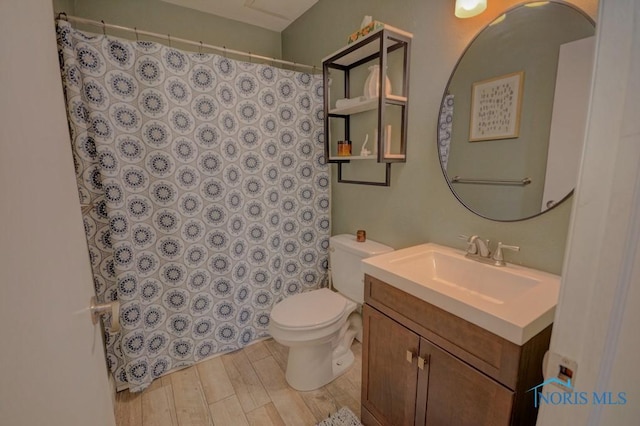 bathroom featuring hardwood / wood-style flooring, vanity, and toilet