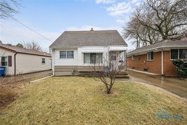 back of house with a lawn