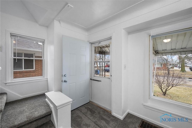 doorway featuring dark colored carpet