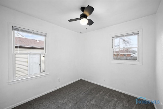 carpeted spare room with ceiling fan