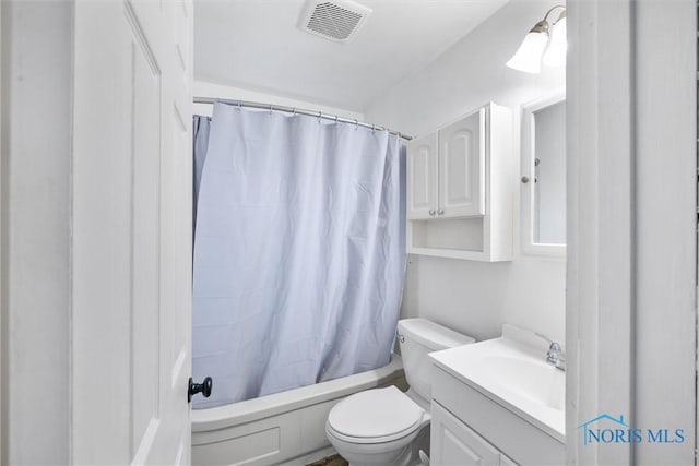 full bathroom with vanity, shower / tub combo, and toilet