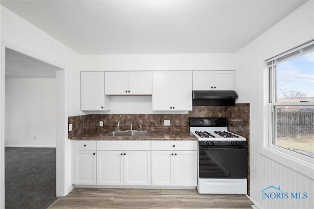 kitchen featuring white cabinetry, sink, decorative backsplash, and range with gas cooktop