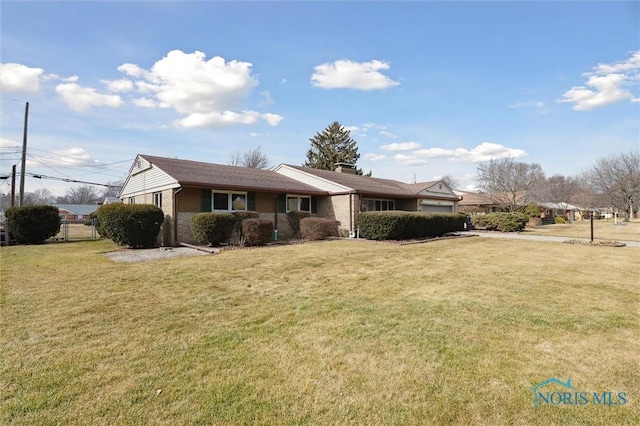 ranch-style house with brick siding, fence, and a front lawn