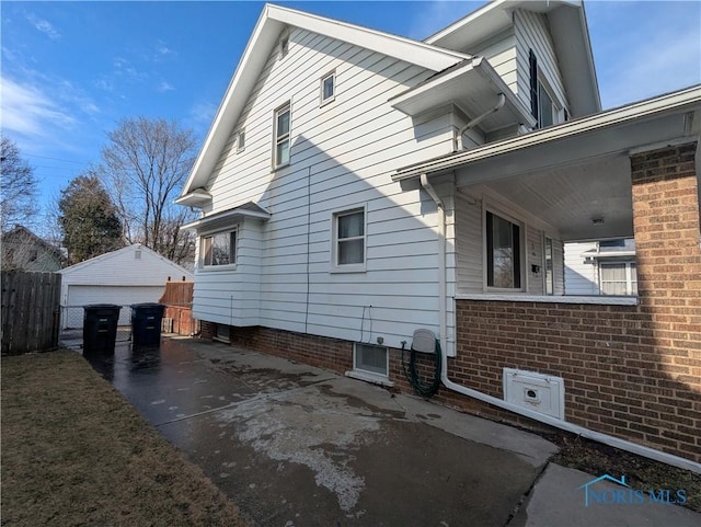 view of side of home with a garage and an outbuilding