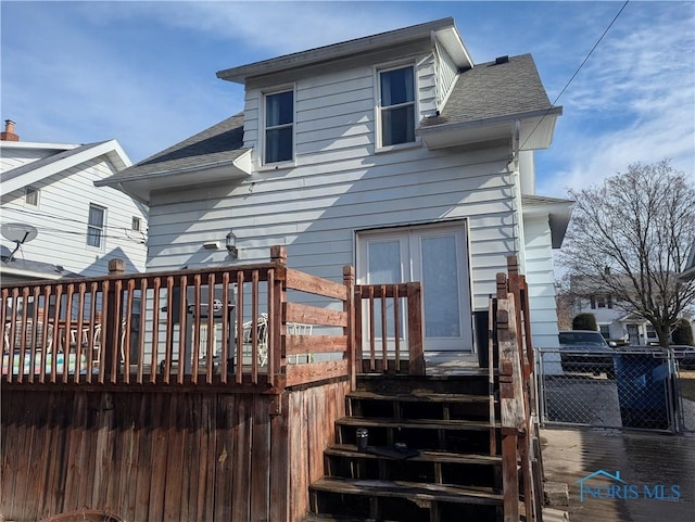 rear view of house featuring a wooden deck