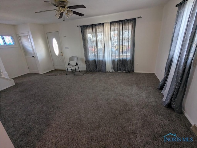 carpeted foyer with ceiling fan