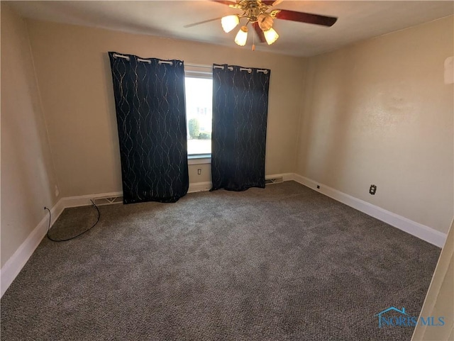 carpeted spare room with ceiling fan