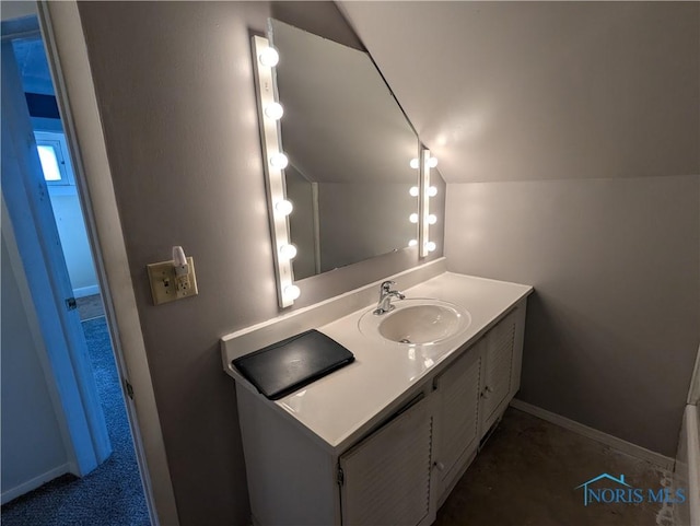 bathroom with vanity and vaulted ceiling