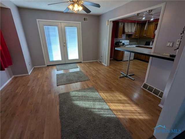 doorway to outside featuring light hardwood / wood-style floors, french doors, and ceiling fan