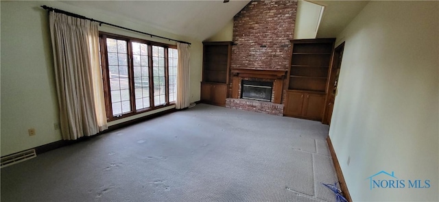 unfurnished living room with carpet floors, a brick fireplace, and vaulted ceiling