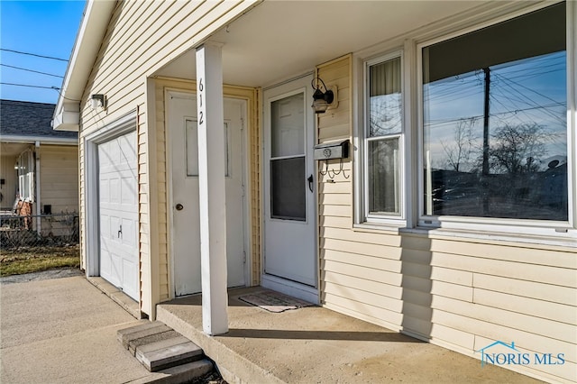 view of exterior entry with a garage