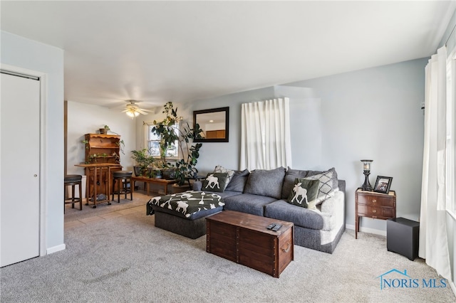 living room featuring ceiling fan and light carpet