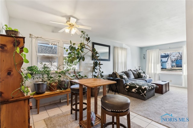 tiled dining space with ceiling fan