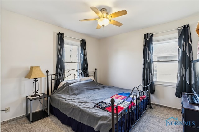 bedroom with ceiling fan and light colored carpet