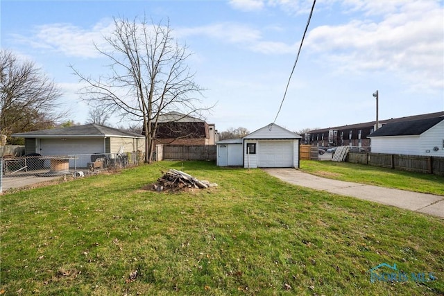 view of yard featuring a garage and an outbuilding