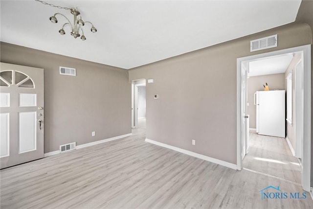 unfurnished room featuring light hardwood / wood-style floors