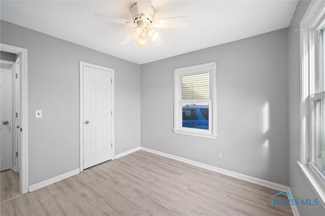 unfurnished bedroom featuring ceiling fan and light hardwood / wood-style flooring