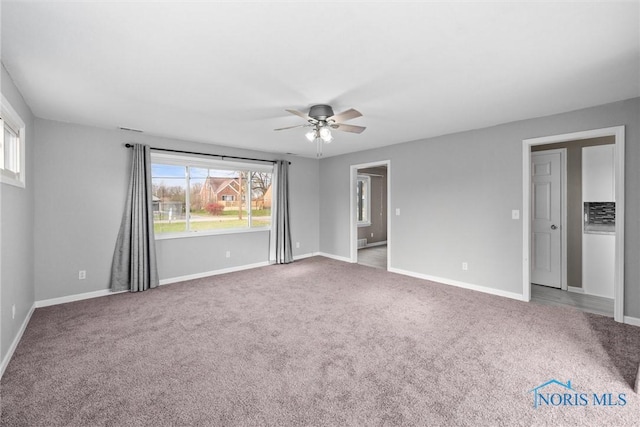 carpeted empty room with ceiling fan