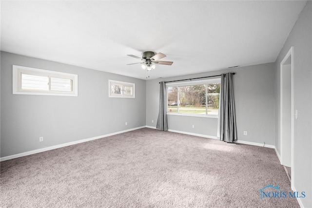 empty room featuring ceiling fan and carpet floors