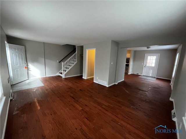 unfurnished living room with dark hardwood / wood-style floors