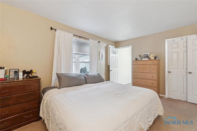 bedroom featuring light colored carpet