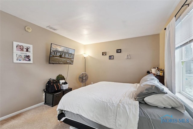 bedroom featuring light colored carpet