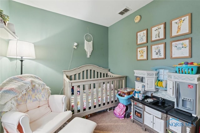 carpeted bedroom with a crib