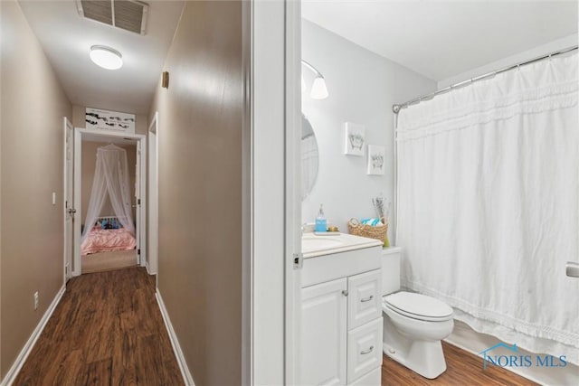 bathroom featuring a shower with curtain, vanity, toilet, and wood-type flooring