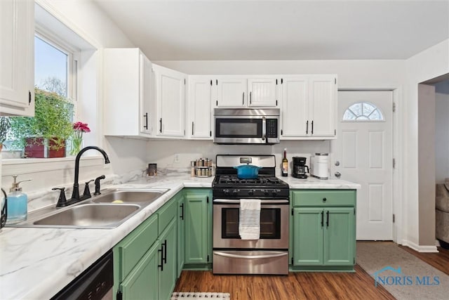 kitchen featuring sink, white cabinets, green cabinetry, stainless steel appliances, and plenty of natural light