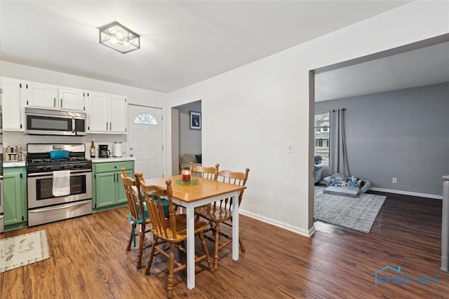 dining area with dark hardwood / wood-style flooring