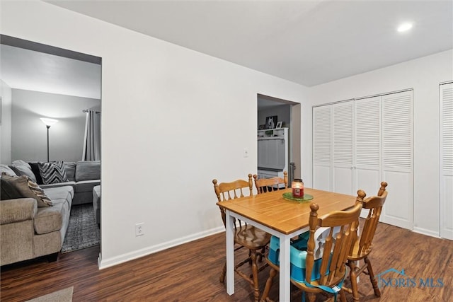 dining space with dark wood-type flooring