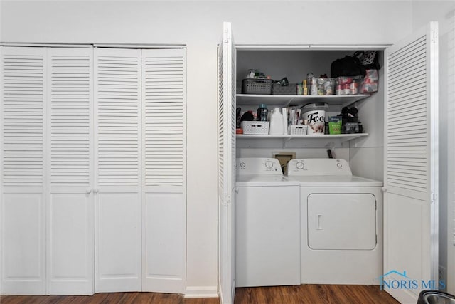 laundry room with dark hardwood / wood-style floors and washer and dryer