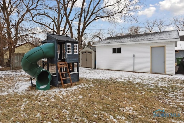 snow covered structure with a playground