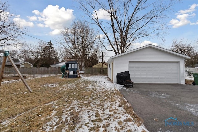 exterior space featuring a garage, an outdoor structure, and a playground