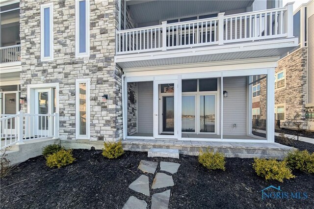 entrance to property with a balcony