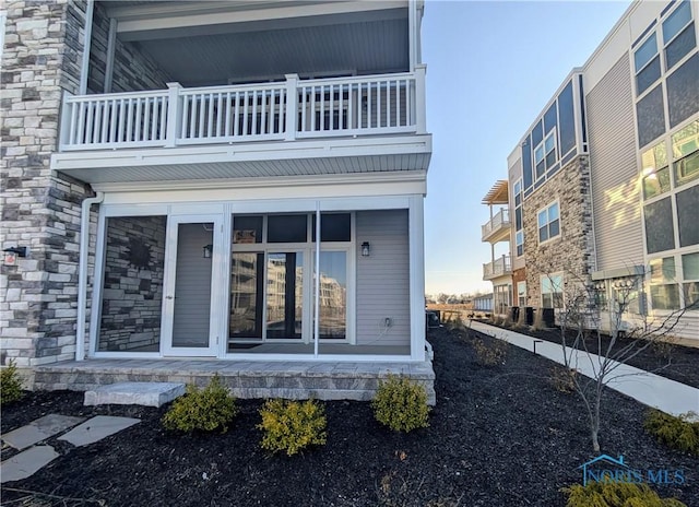 rear view of property with a balcony