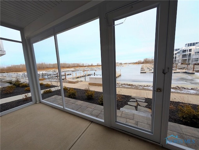 entryway featuring a water view and a wealth of natural light