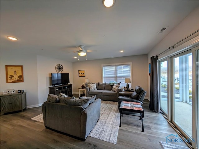 living room with hardwood / wood-style floors and ceiling fan