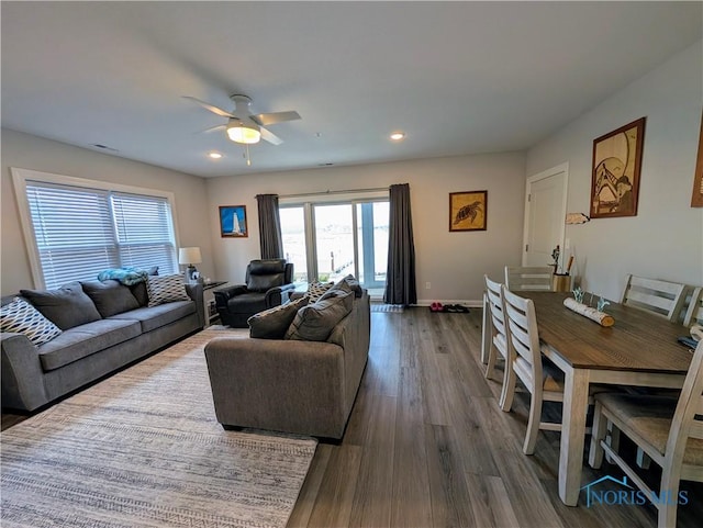 living room with ceiling fan and dark hardwood / wood-style flooring