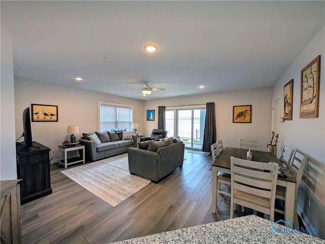 living room featuring hardwood / wood-style flooring and ceiling fan