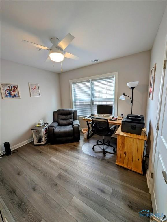 office with wood-type flooring and ceiling fan