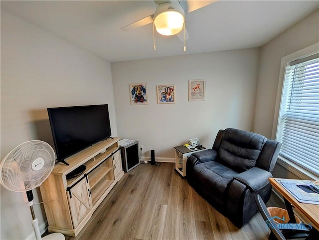 living room featuring ceiling fan and light hardwood / wood-style flooring