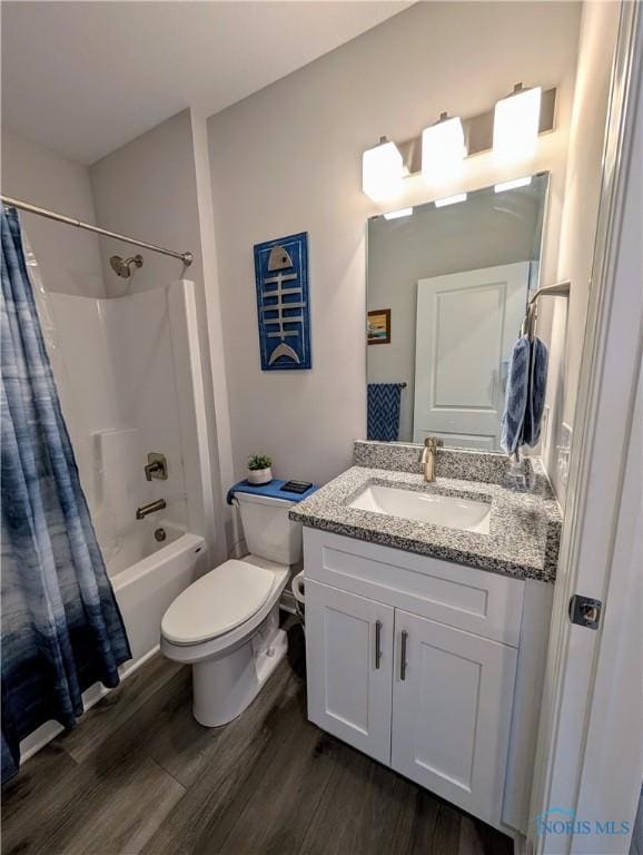 full bathroom with vanity, hardwood / wood-style floors, shower / bath combination with curtain, and toilet