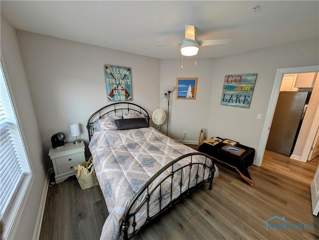 bedroom featuring ceiling fan and dark hardwood / wood-style floors