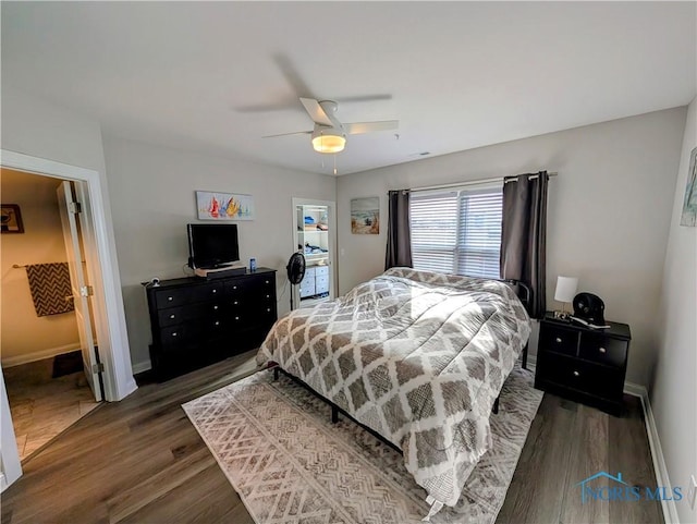 bedroom with ceiling fan and dark hardwood / wood-style flooring