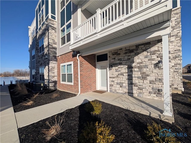 property entrance with central AC and a balcony