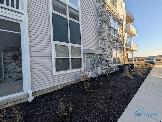 view of property exterior with central AC unit